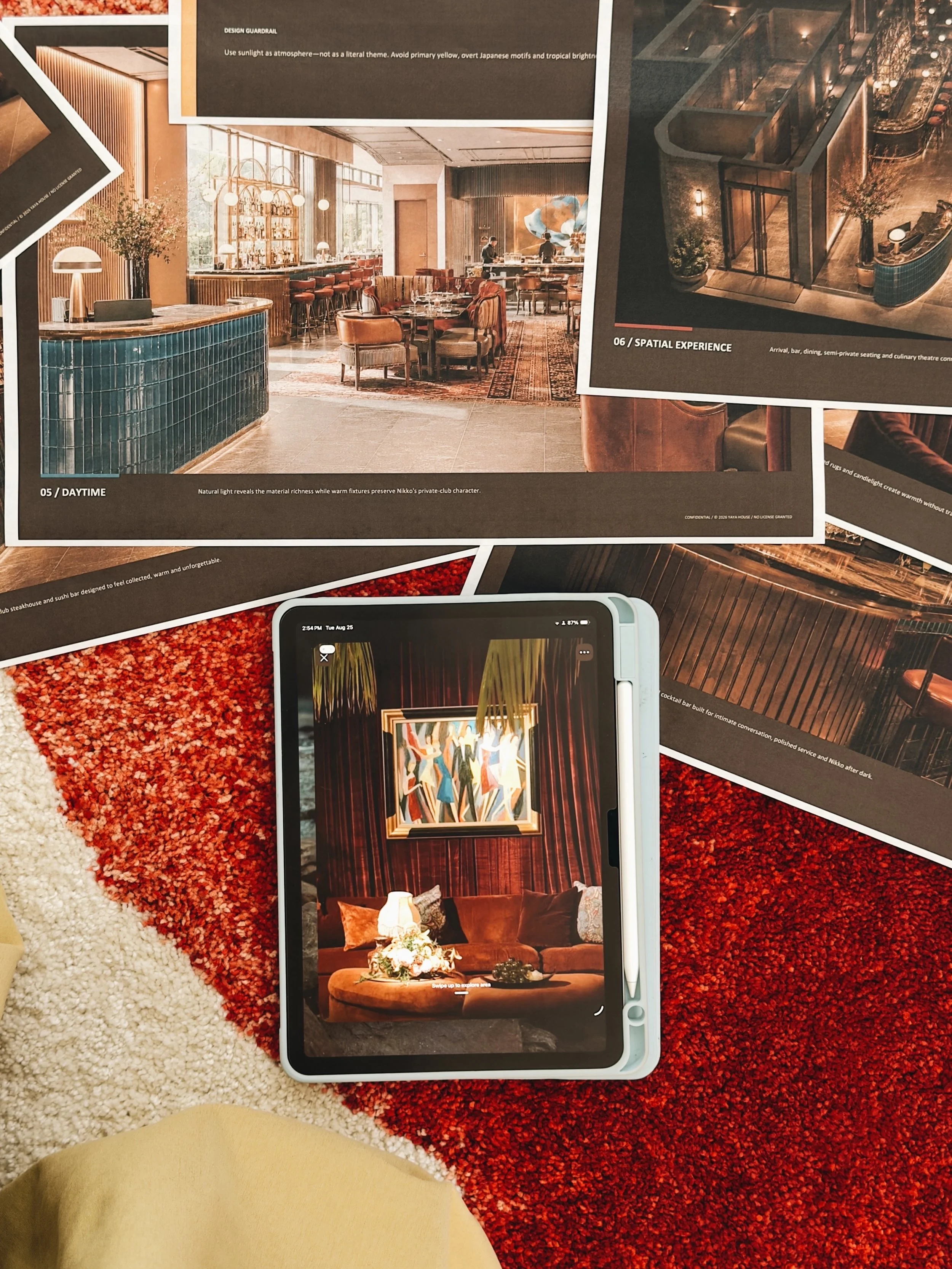 A collage of interior design images featuring a restaurant and lounge area with modern decor, warm lighting, and stylish furniture, scattered on a red and white textured carpet.