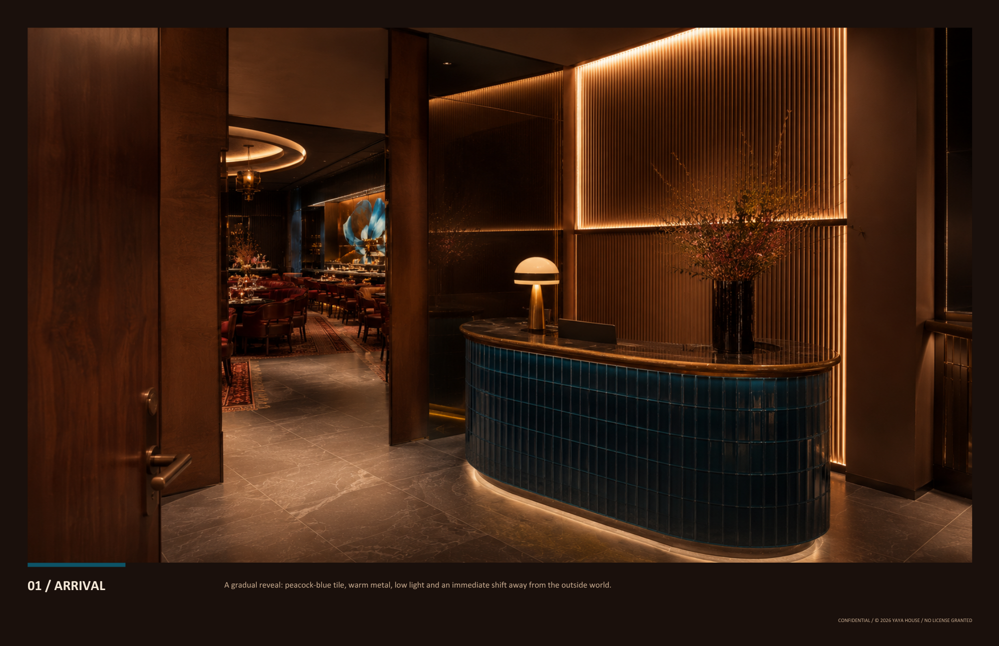 Luxurious hotel lobby entrance with warm lighting, a black tiled reception desk with a flower arrangement, and a lounge area with tables set for dining in the background.