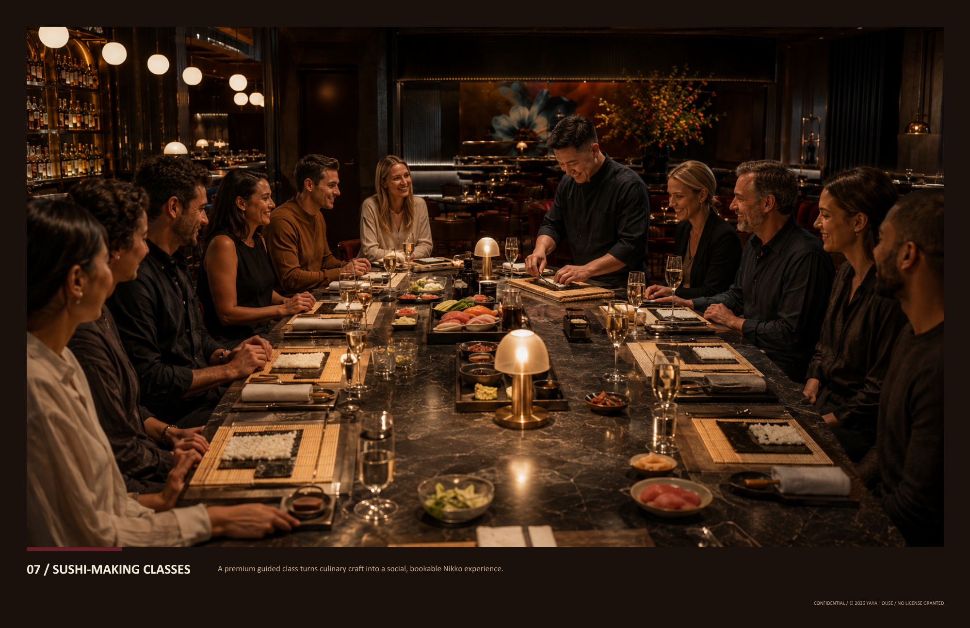 People sitting at a long sushi-making table in a dimly lit, elegant restaurant, receiving a demonstration from the chef in the center.