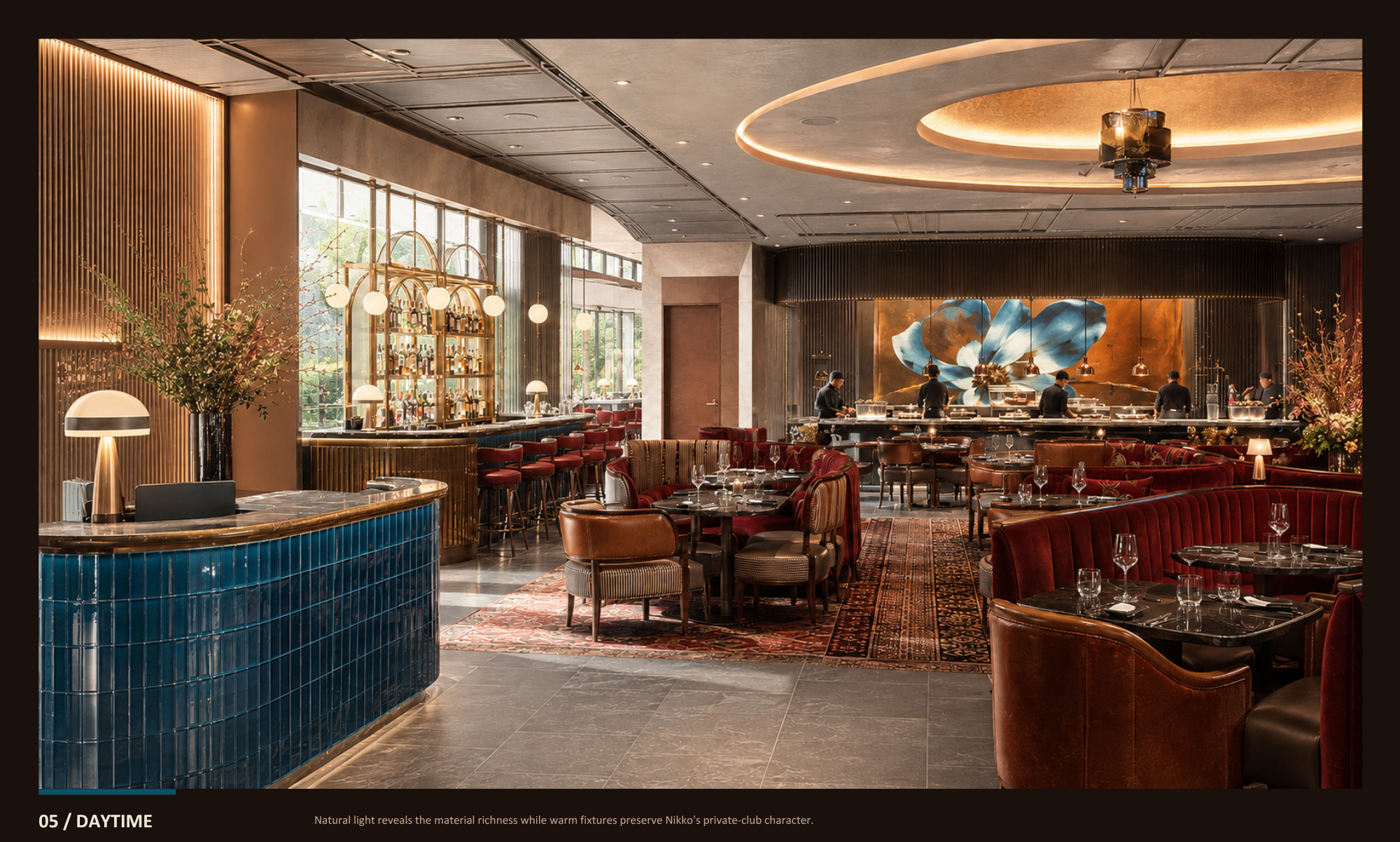 Elegant restaurant interior with plush red seating, a bar area with bottles on display, and a kitchen with chefs at work. Large windows, warm lighting, and artistic wall decor create a sophisticated ambiance.