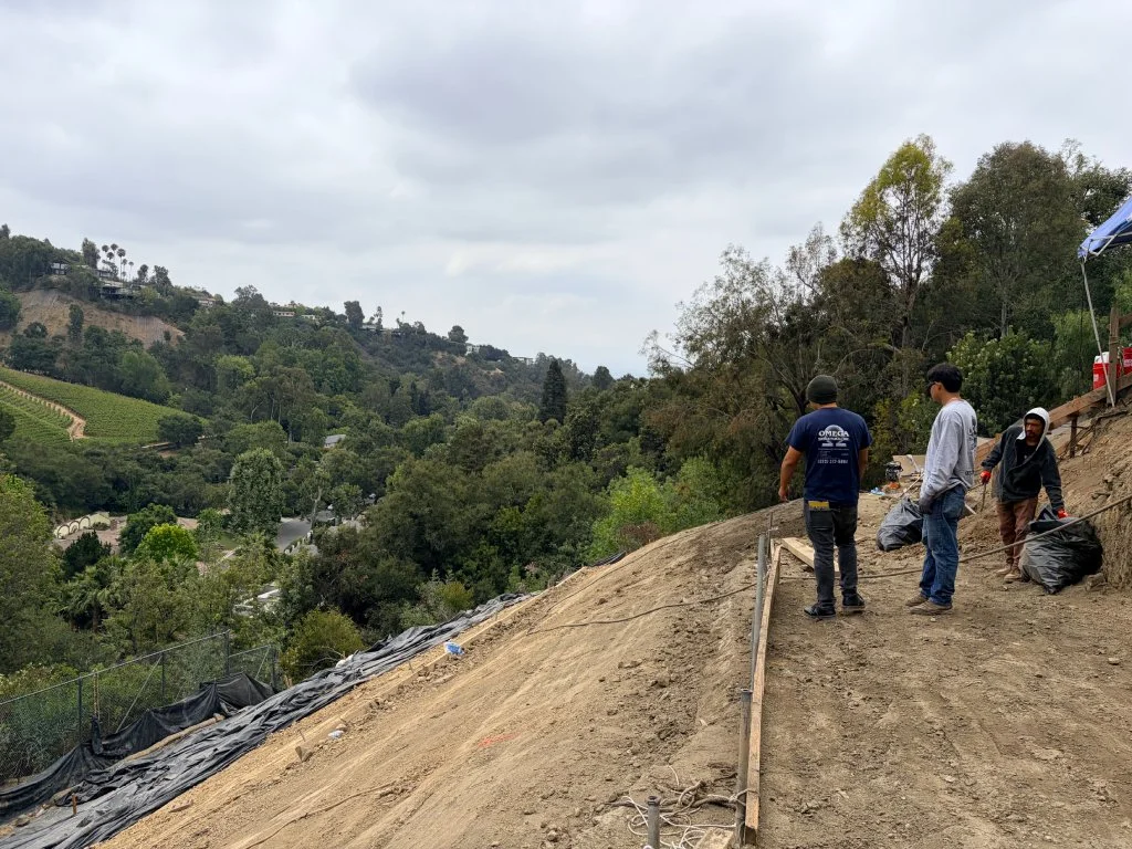 Workers Standing Hill Side Work Site