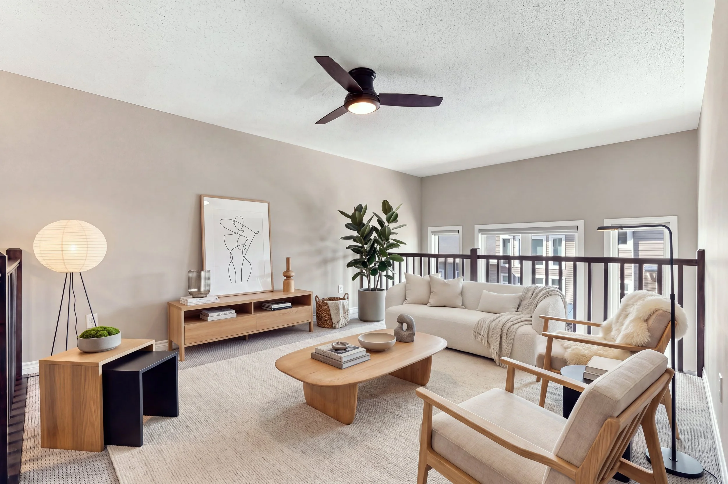 Bright living room with beige sofa and wooden coffee table, professional real estate photography Ottawa