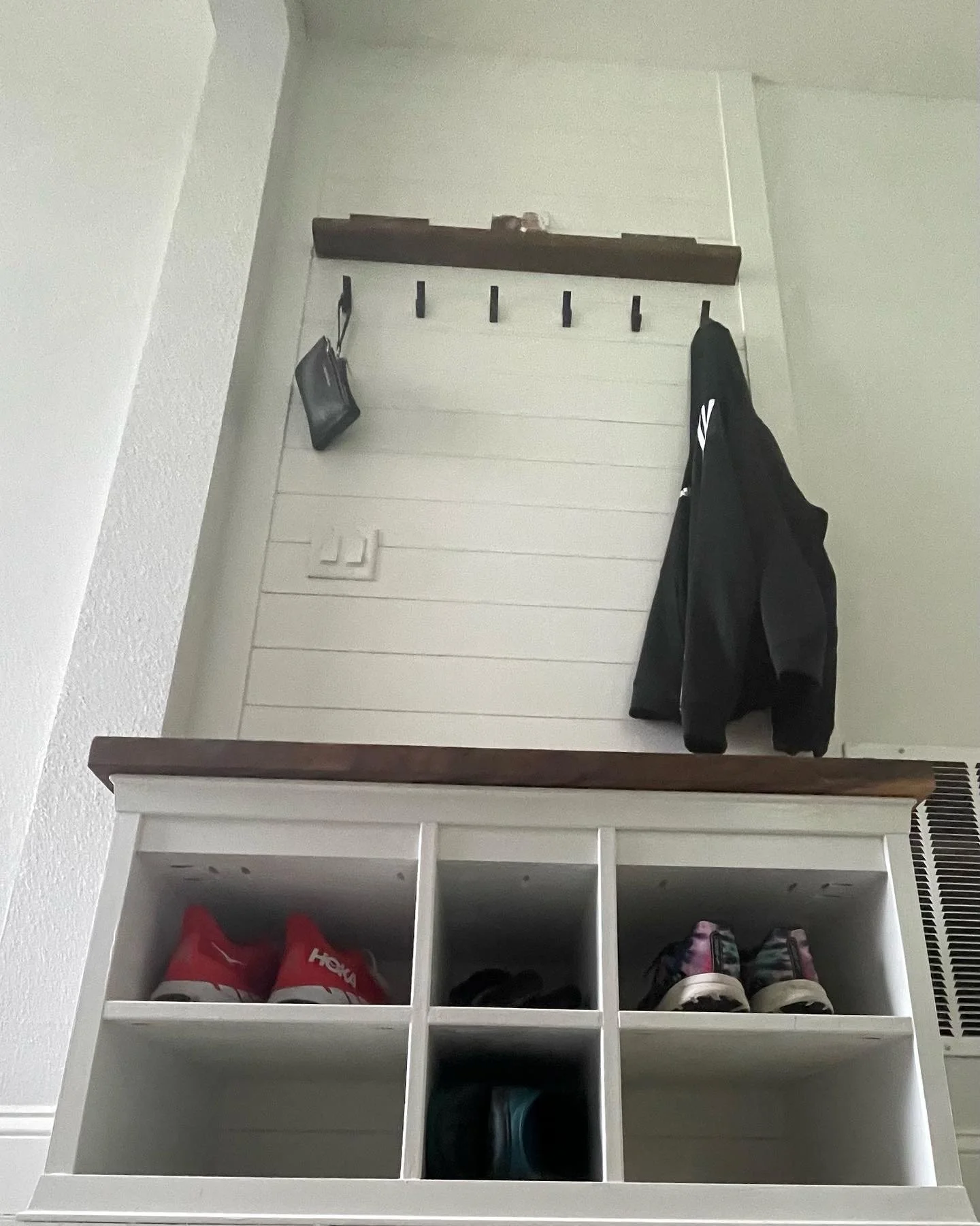 Installed and painted shiplap accent wall. Saman hardwood bench seat and wooden shelf. Shoe and bench seat storage.