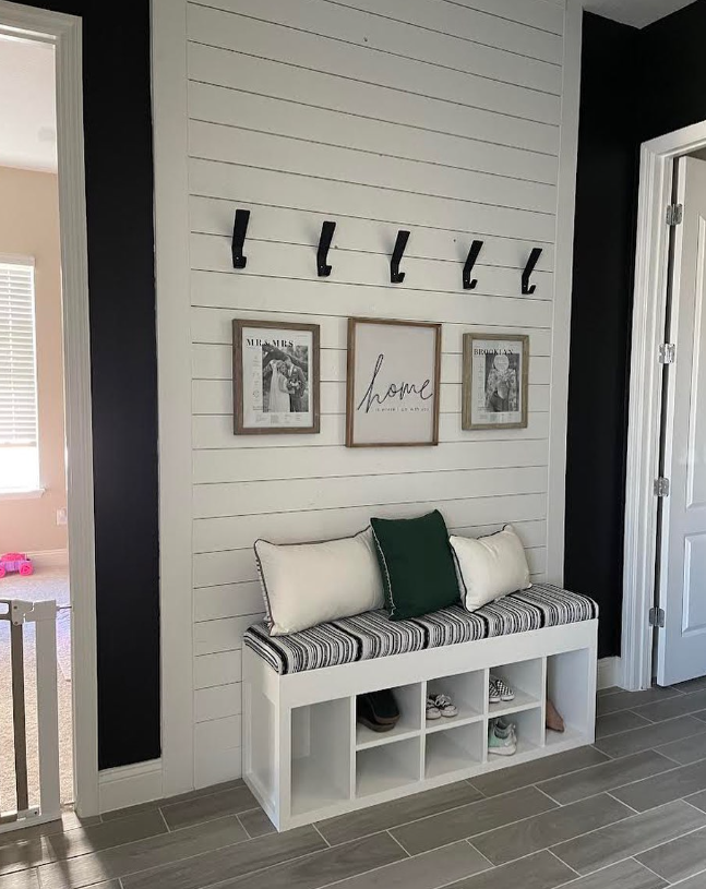 Installed and painted shiplap accent wall. Custom upholstered seat with extensive shoe storage.
