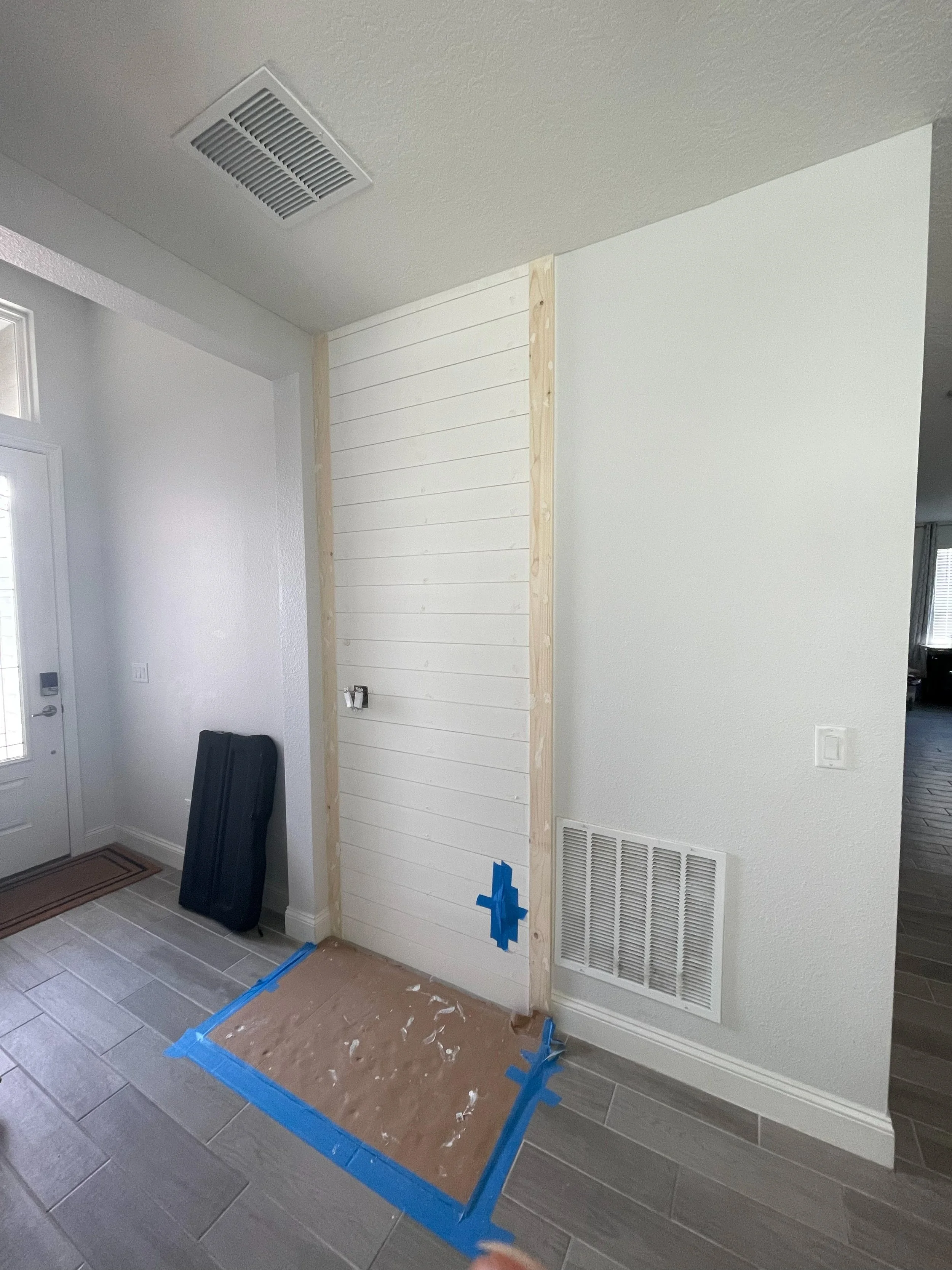 Installed and painted shiplap accent wall. (click next photo to see bench and hanging area)