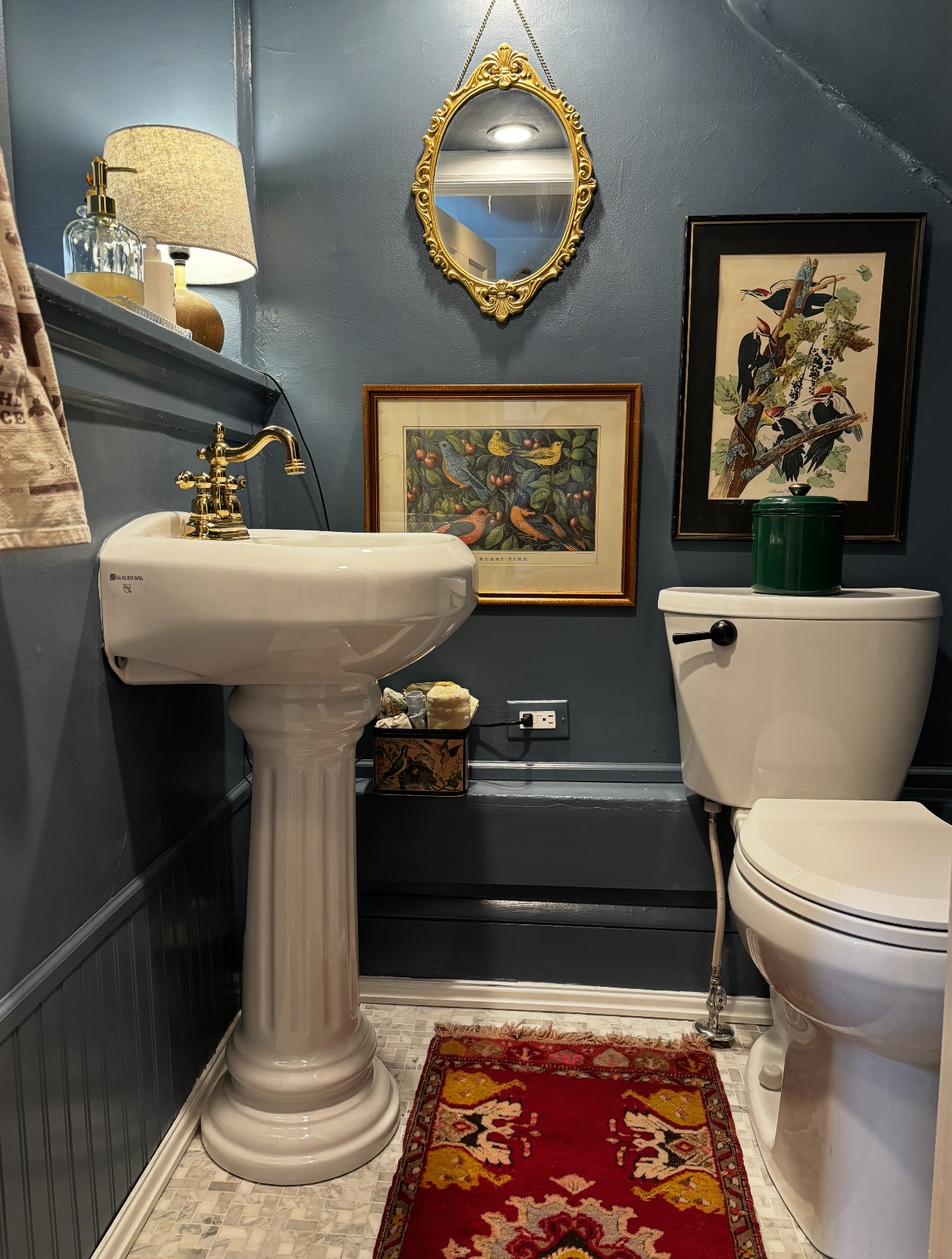 The smallest bathroom, made cozy with a denim blue paint and lots of texture and fun wall hangings.