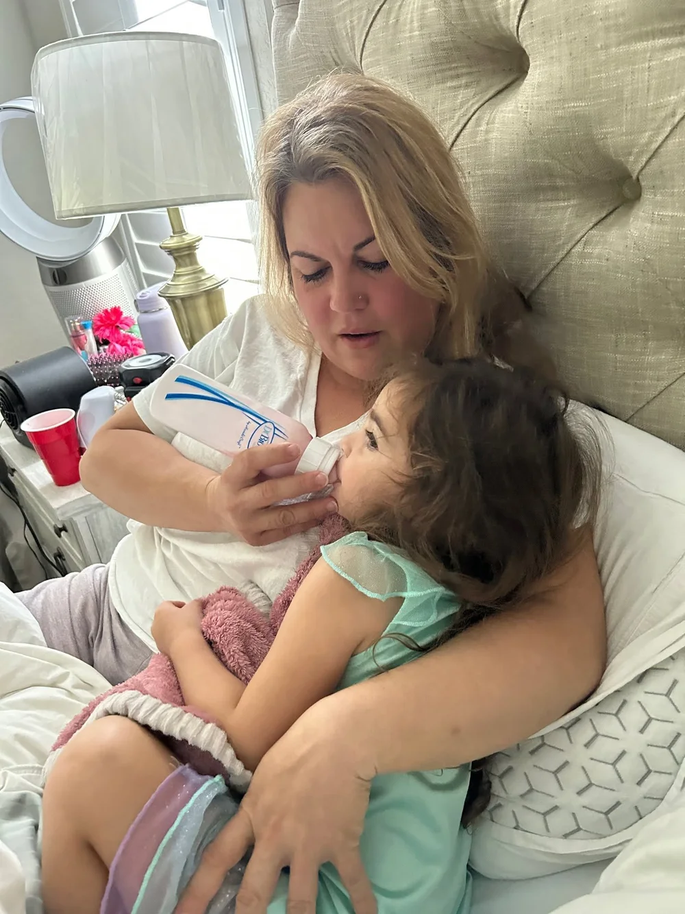 Elizabeth Hernandez in bed with her youngest daughter