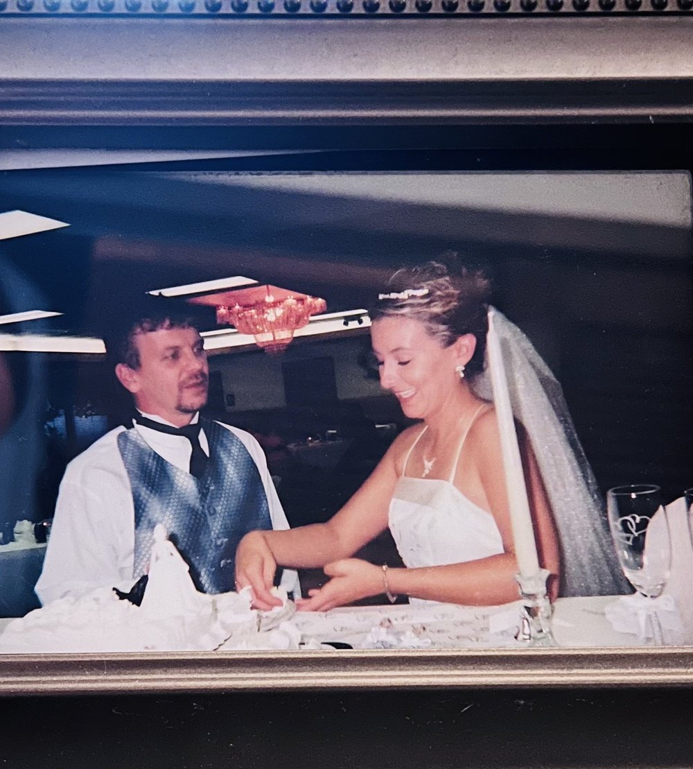 Douglas Vance and Heather cutting the cake on their wedding day
