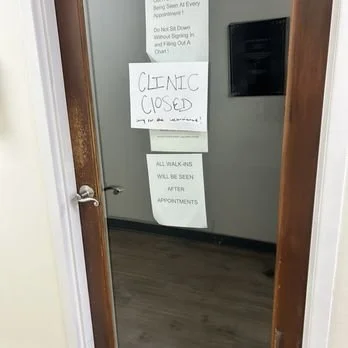 A door with two signs indicating the clinic is closed and instructing that all walk-ins will be seen after appointments.