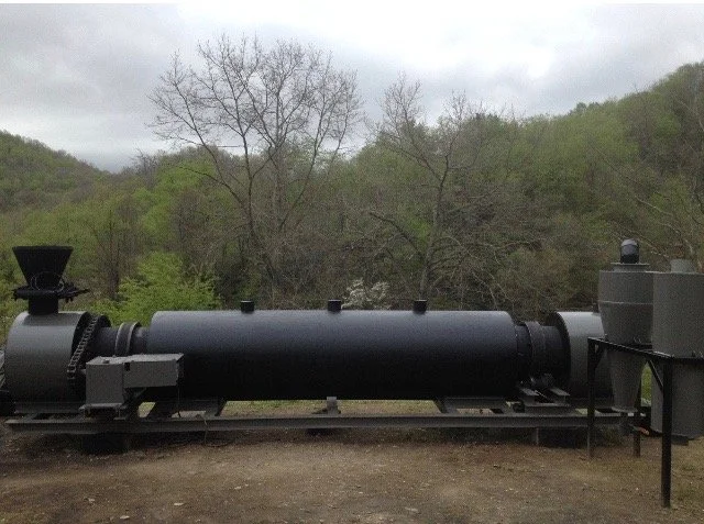 The rotary kiln, or calciner, built by Douglas Vance, standing on steel rails in the Kentucky hills