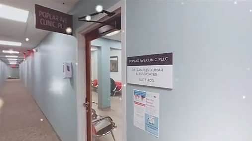Door plaque in an office building corridor reading Poplar Ave Clinic PLLC, Dr. Sanjeev Kumar and Associates, Suite 400