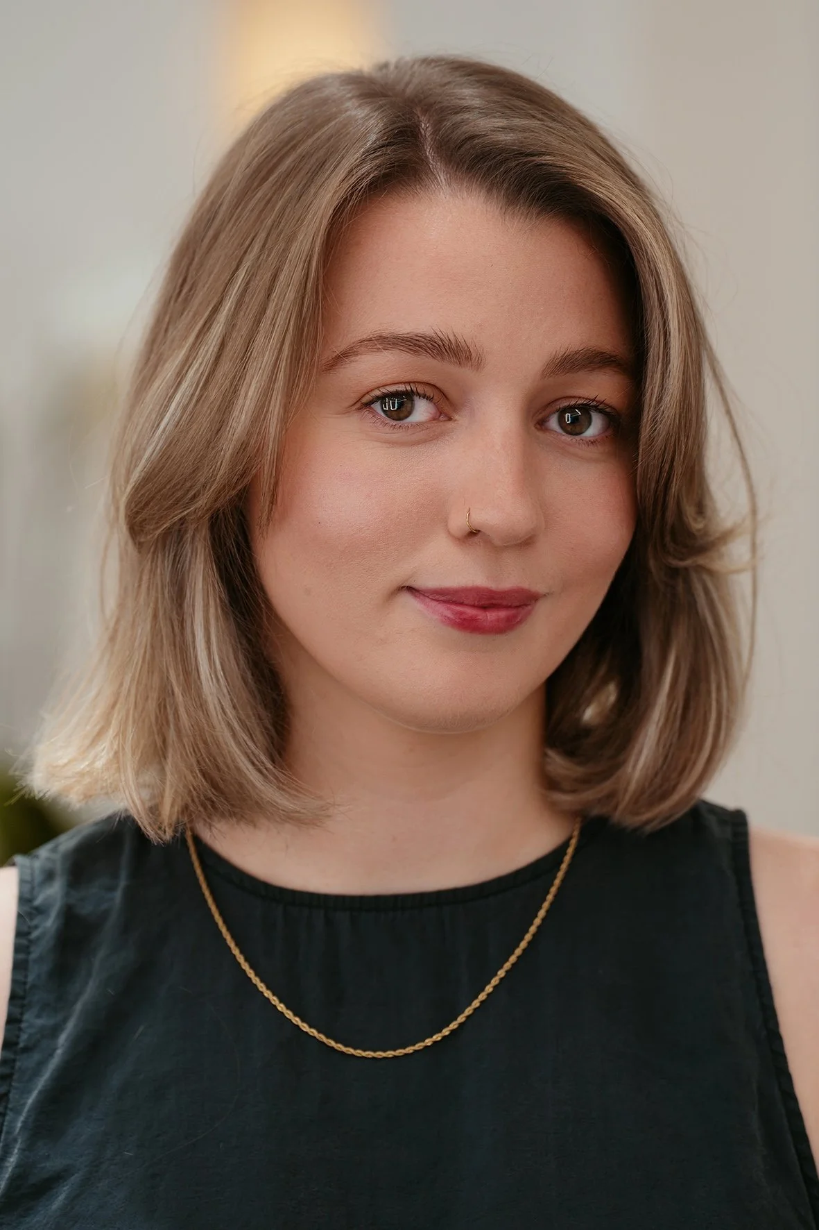 just above the shoulder soft haircut with a soft framing fringe, and soft blonde highlights by Kash Bishop.