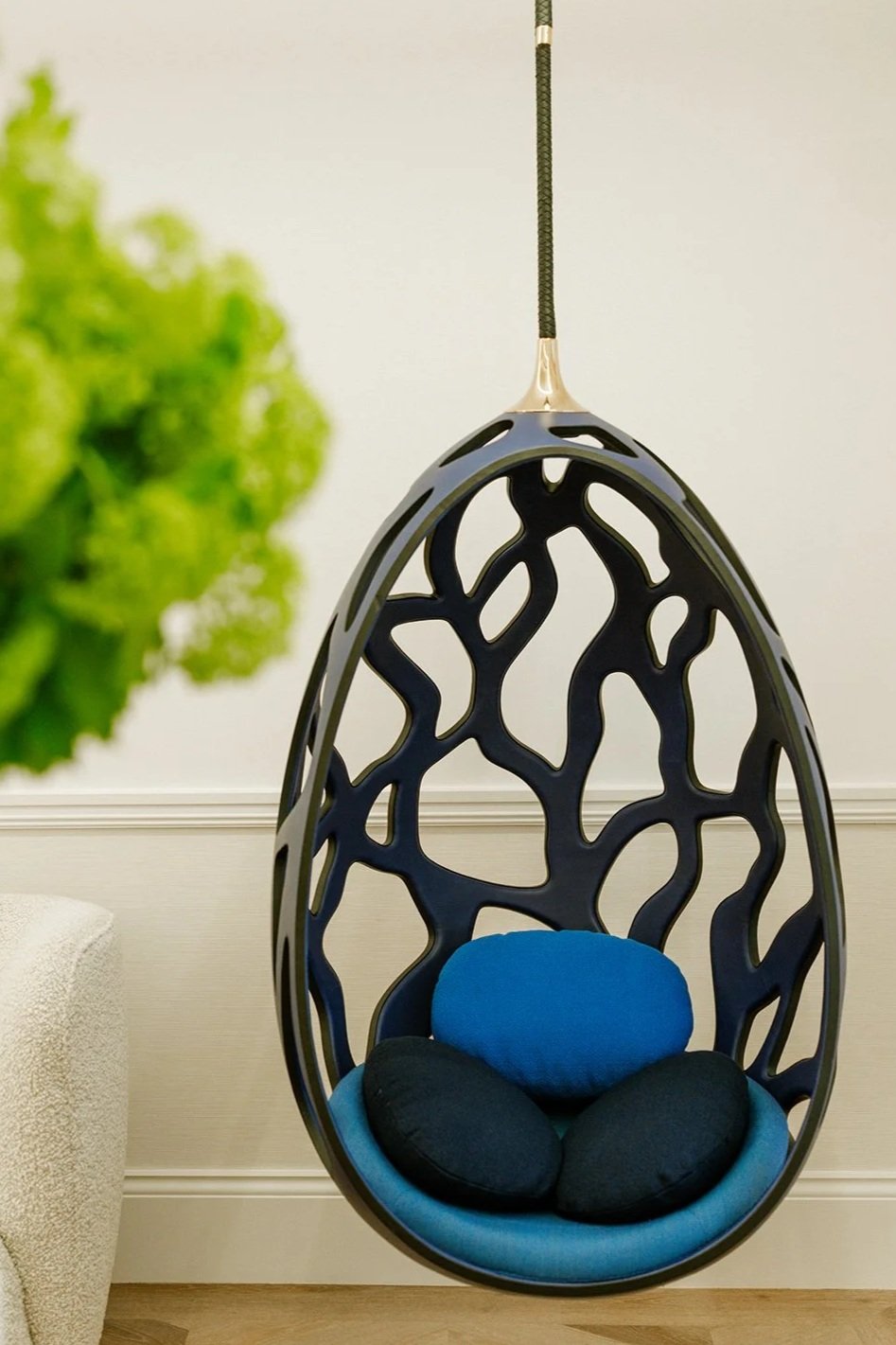 a cocoon swing chair hanging from the ceiling in the reception area at The Six, Mayfair, London.