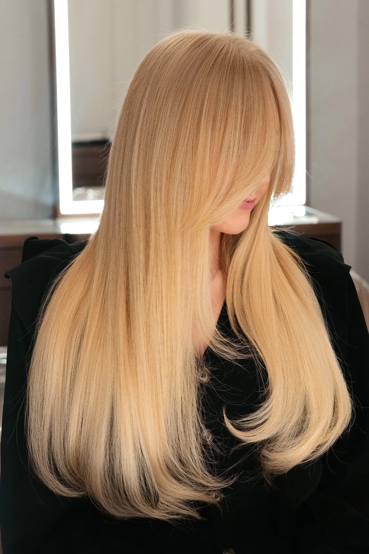 A woman with long, straight blonde hair extensions at The Six, Mayfair.