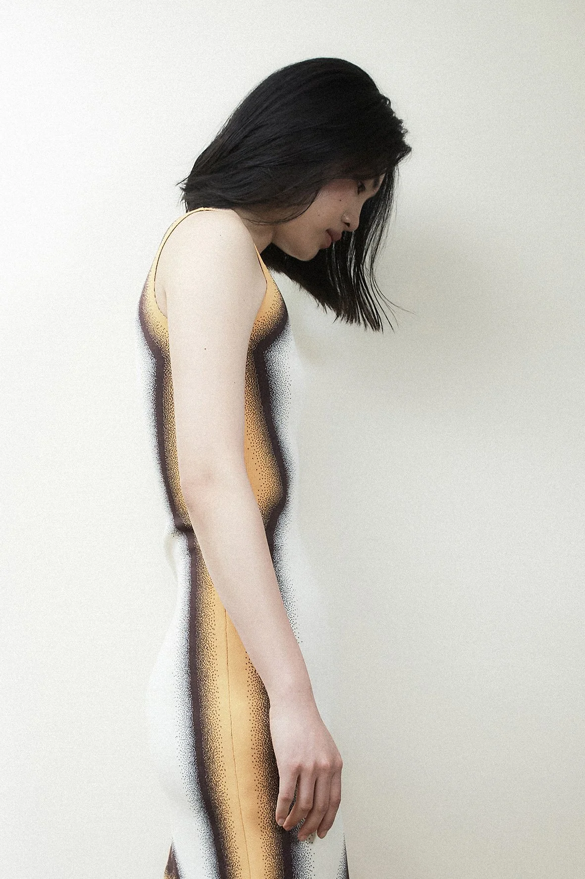A woman with above shoulder-length bob hair cut and dark brown hair colour by Domenico Sansone.