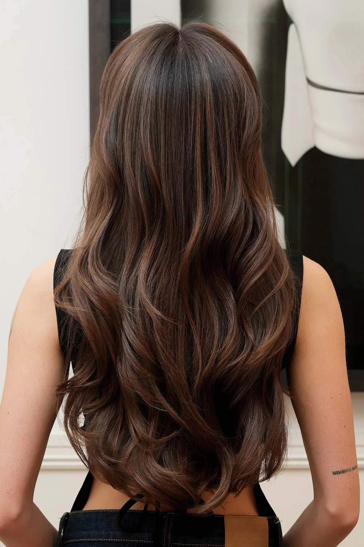 long soft wave styled hair with a dark, rich, chocolate brown and soft warm sun kissed balayage by Dani Caldeira.