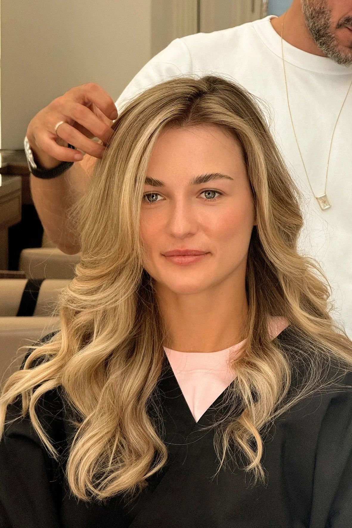 A woman with long natural blonde highlights and soft, bouncy blow dry by Marcos Verissimo at The Six, Mayfair.