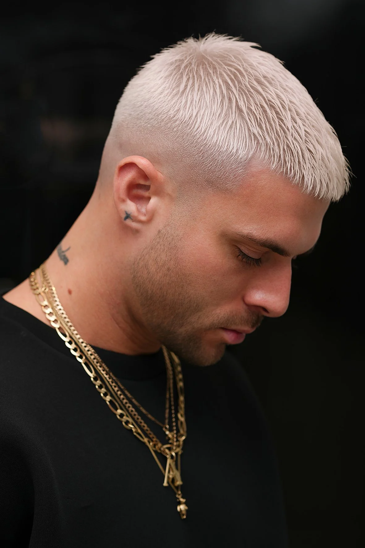 A man with short, platinum blonde bleached and tone.