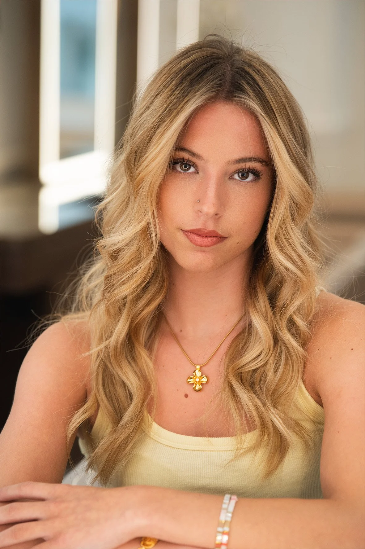 Natural blonde balayage with face framing, long soft wave by Nana Howe.