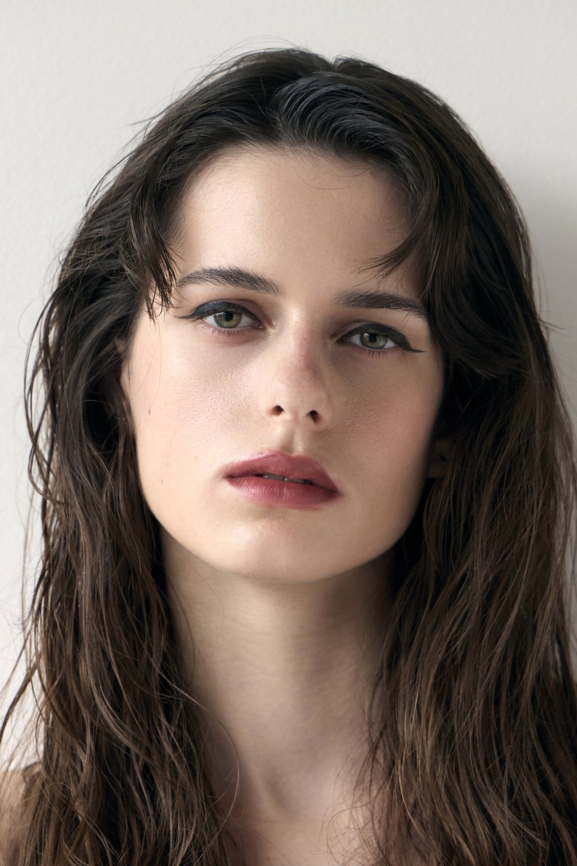 Close-up of a woman's face with long, natural textured wavy hair style by Domenico Sansone at The Six, Mayfair.