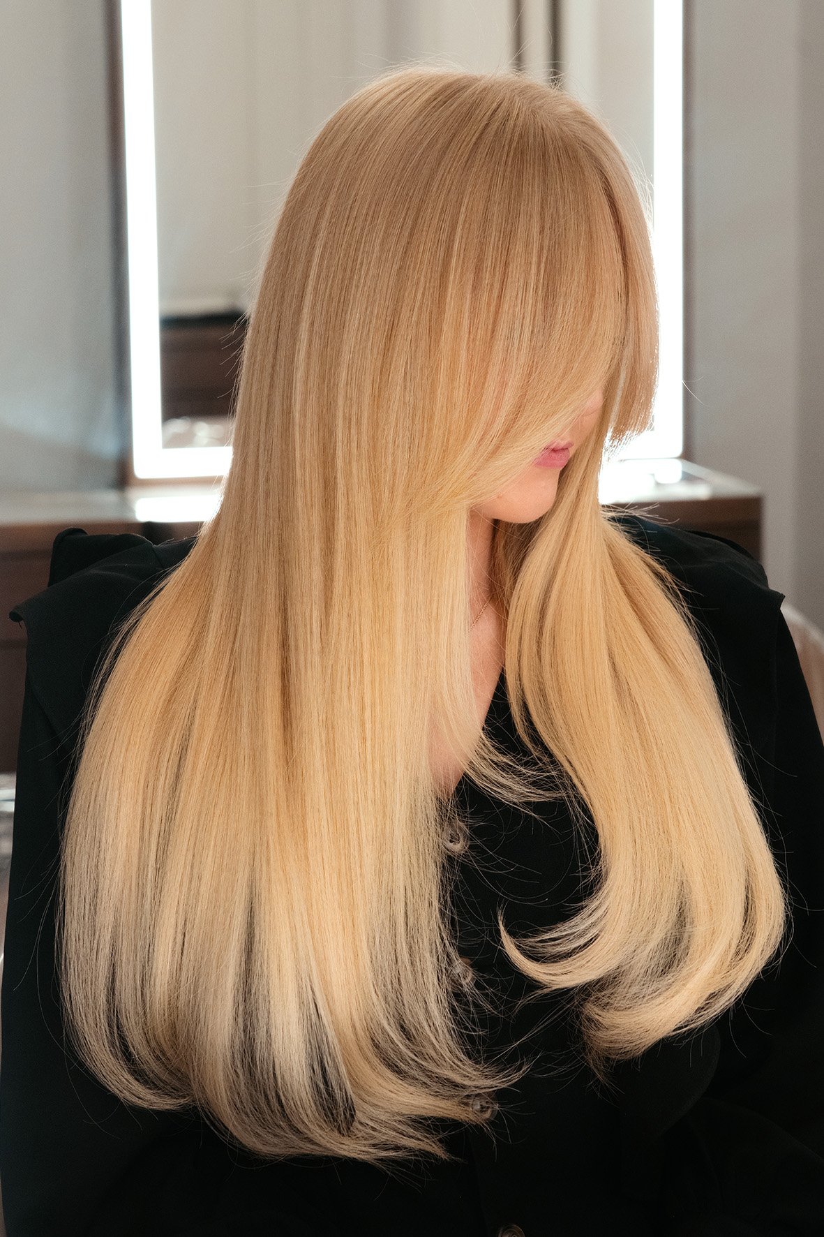 Soft warm light blonde colour with a smooth blow dry by Stephen Jarvis.