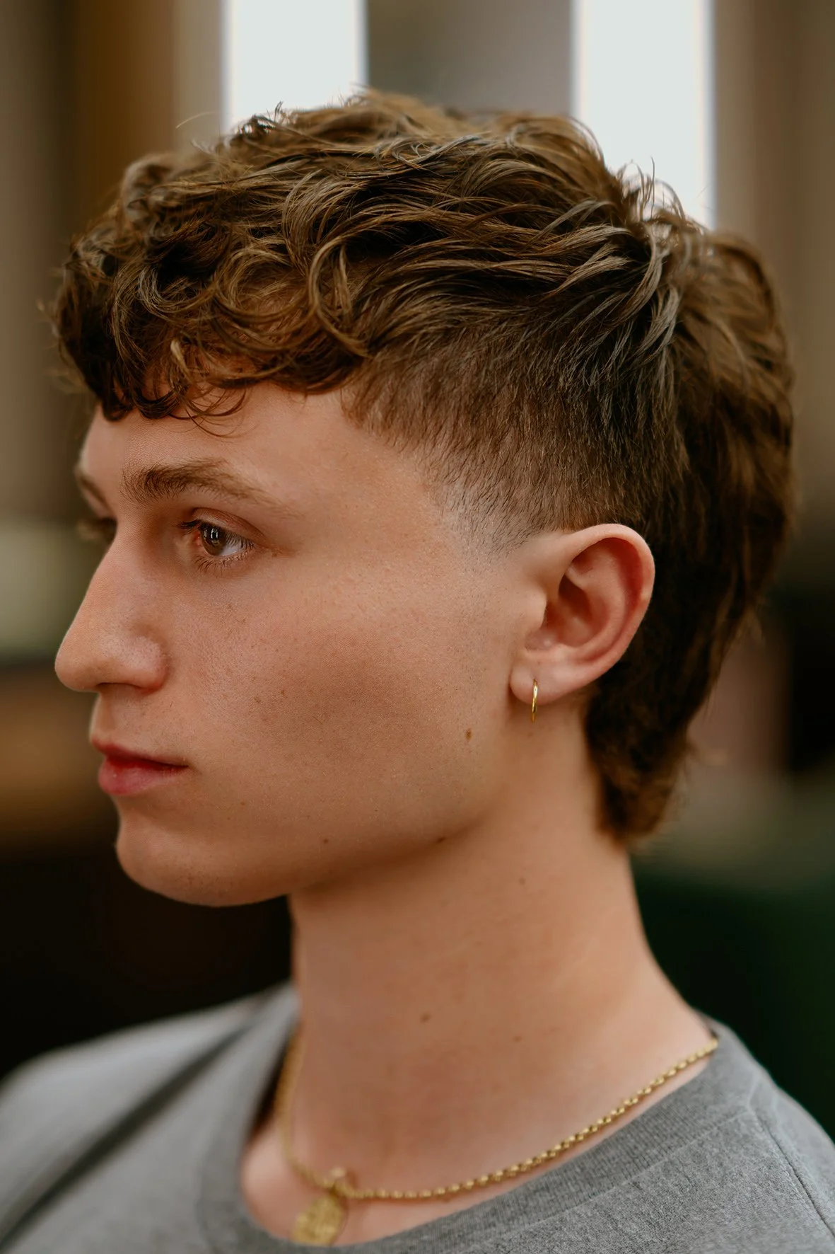 gent's haircut with soft natural texture on the top and short fading on the side by Milad.