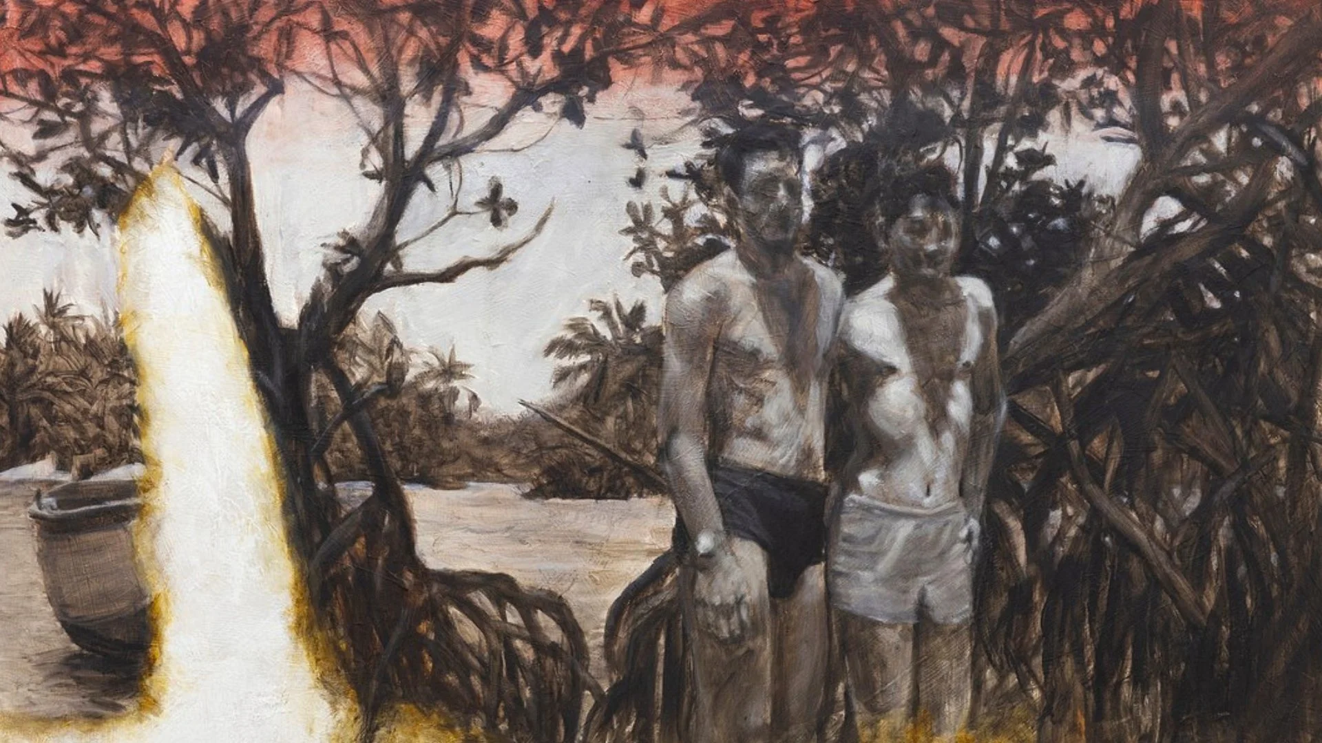 Two young men standing outdoors under a mangrove.