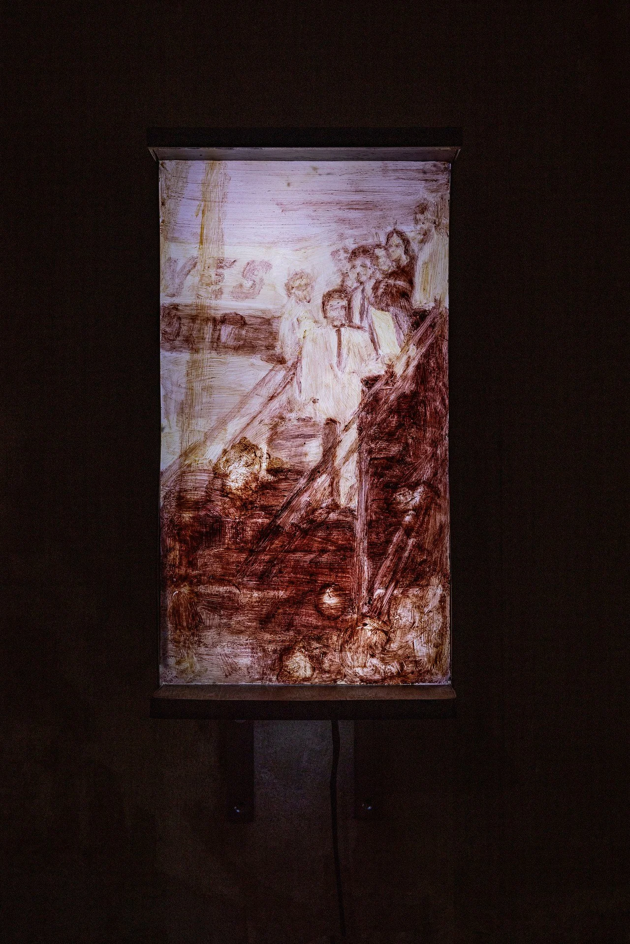 An office cabinet glowing from the inside and onto a painting carefully placed above it.