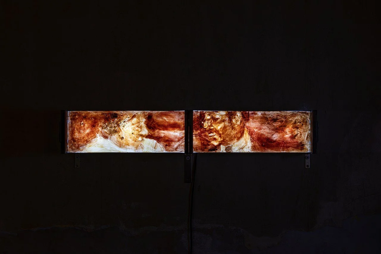 An office cabinet glowing from the inside and onto a painting carefully placed above it.
