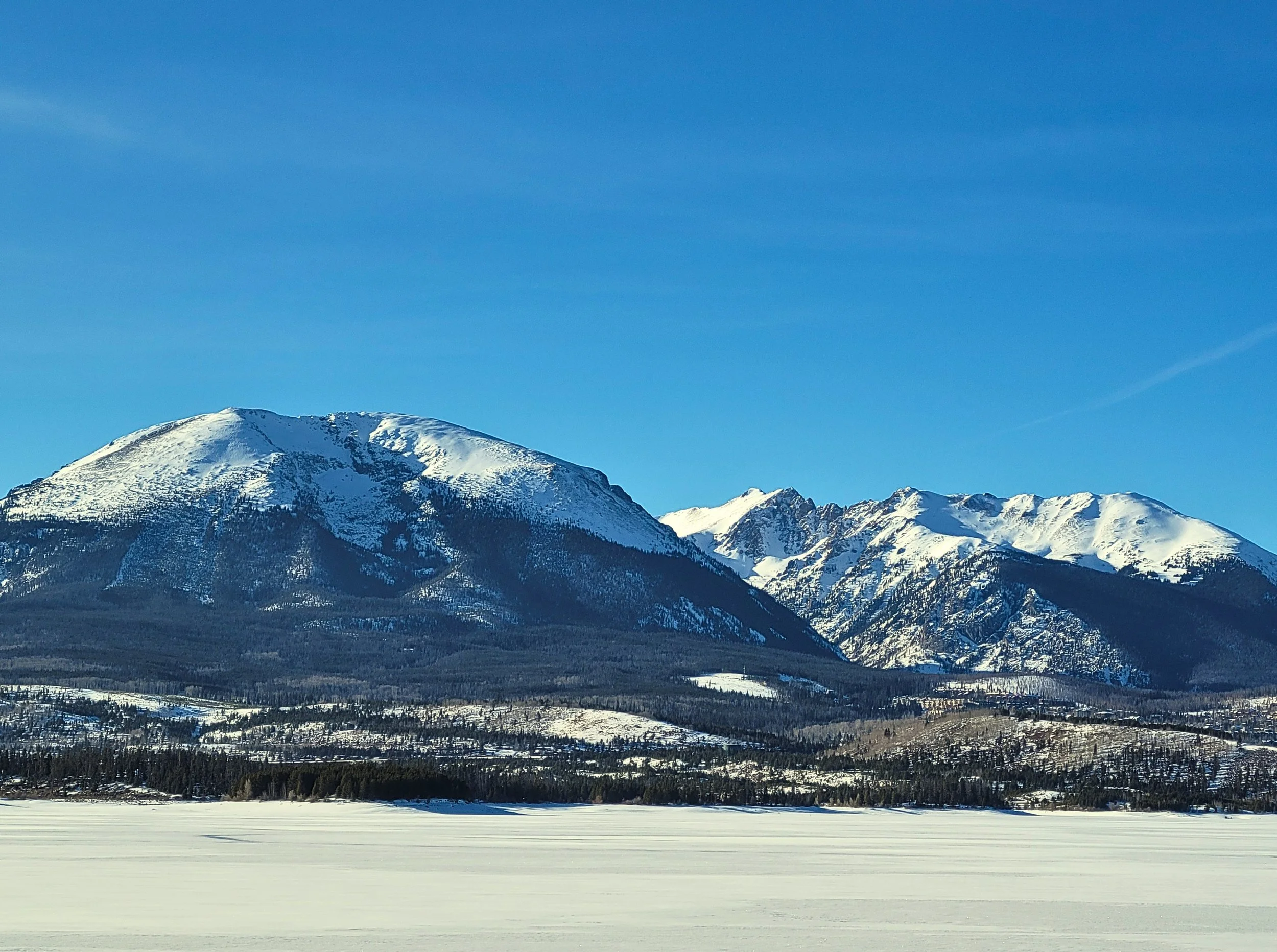 A view of Buffalo Mountain and Red Mountain from an ice covered Lake Dillon in Silverthorne, Colorado.