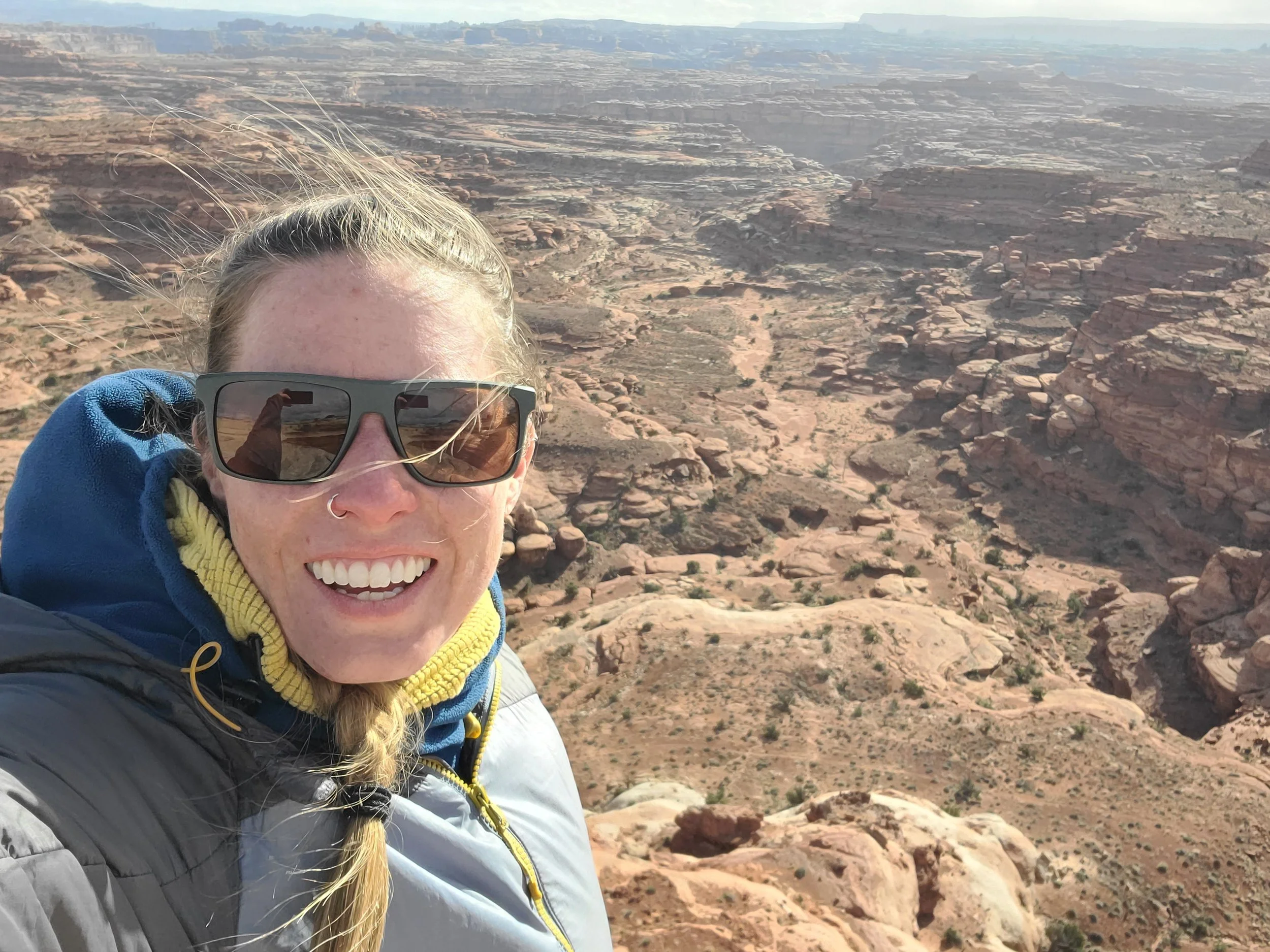 Amy Drees smiling in front of the Rim Canyon in Utah.