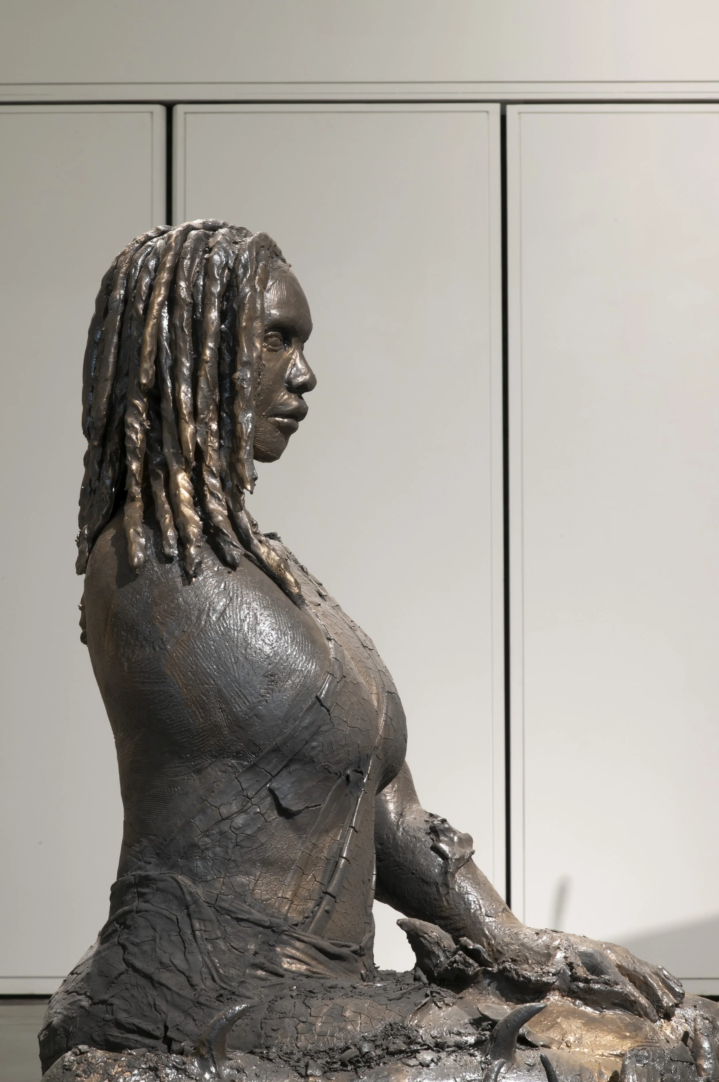 Like A Thorn, side profile
Glazed stoneware, 2023

Like A Thorn is a ceramic figure of a Black woman who is an amputee, seated with their legs and the surrounding base as a bed of thorns. Her pose is relaxed and her gaze is fixed ahead. She is wearin