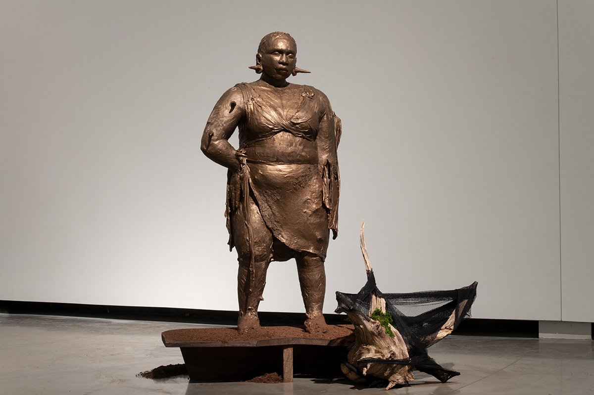 Tread lightly
Stoneware, metallic stain
H 64” w 32” d 18”

The representational Black, life-size ceramic sculpture looks like
bronze and rich soil. She has short cropped hair and is full-figured. Thorns protrude
outward from the gauges in her ears an