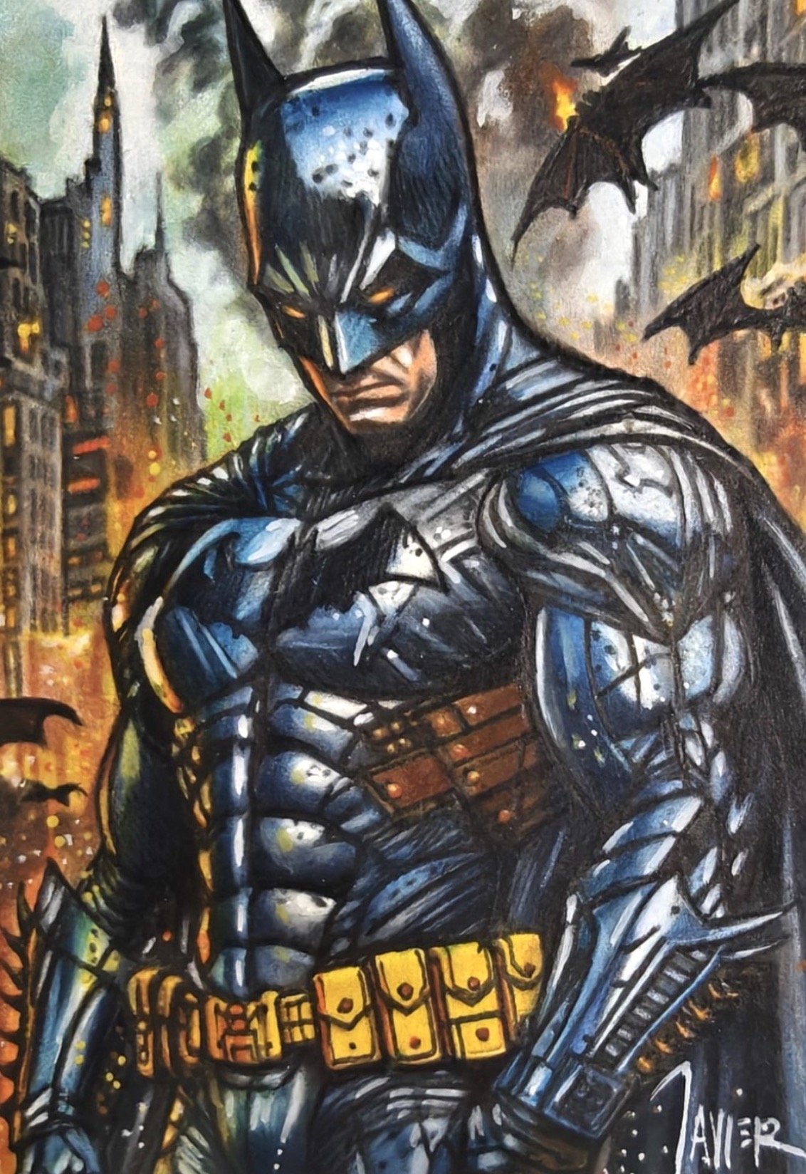 Batman sketch card by Javier. Painting of Batman with a serious expression in a cityscape background with flying bats and burning buildings.