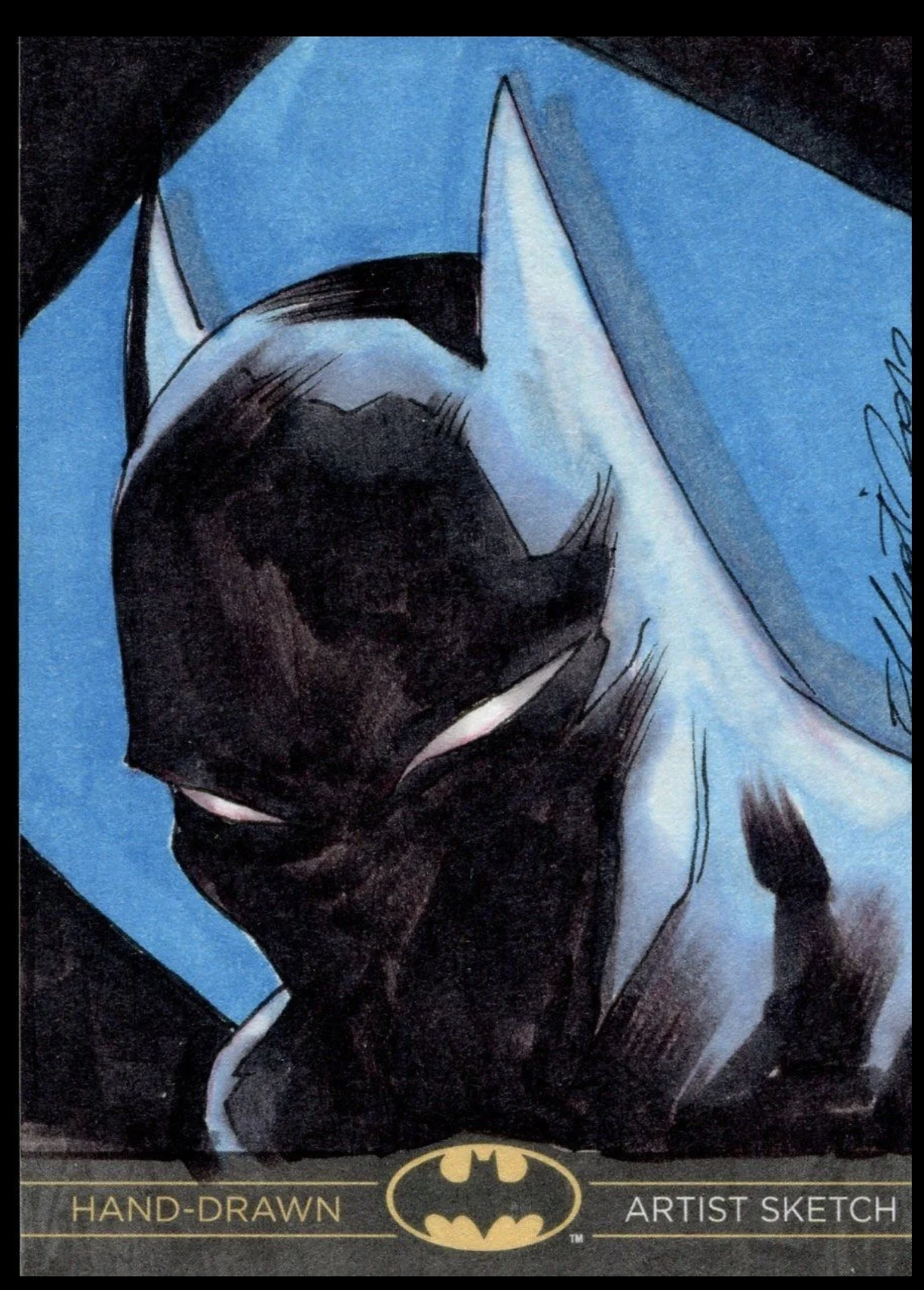 Batman legend sketch card. Hand-drawn Batman sketch on blue paper with black ink, featuring Batman's face and the iconic bat symbol at the bottom.