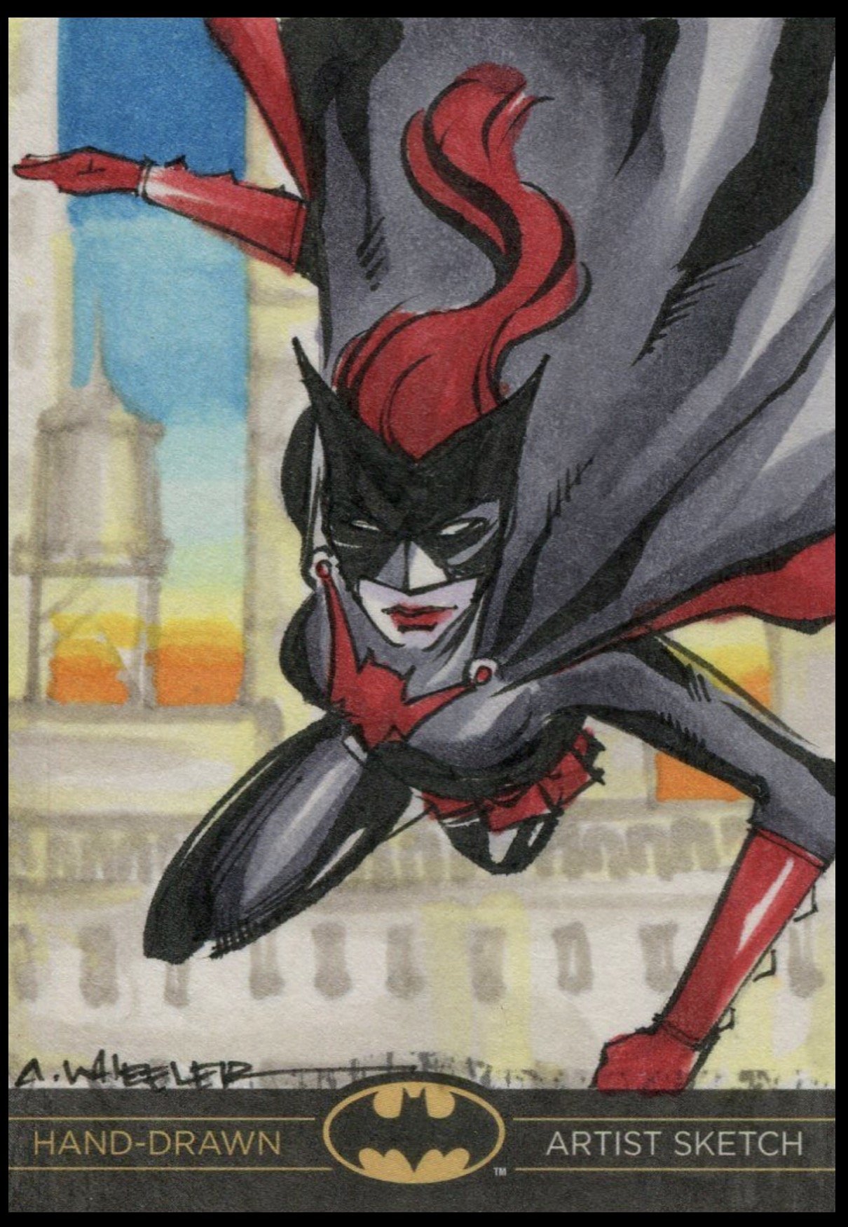 Batman legend sketch card. Hand-drawn image of Batman in a dynamic pose with a red cape and mask, set against a cityscape background with buildings and a water tower.