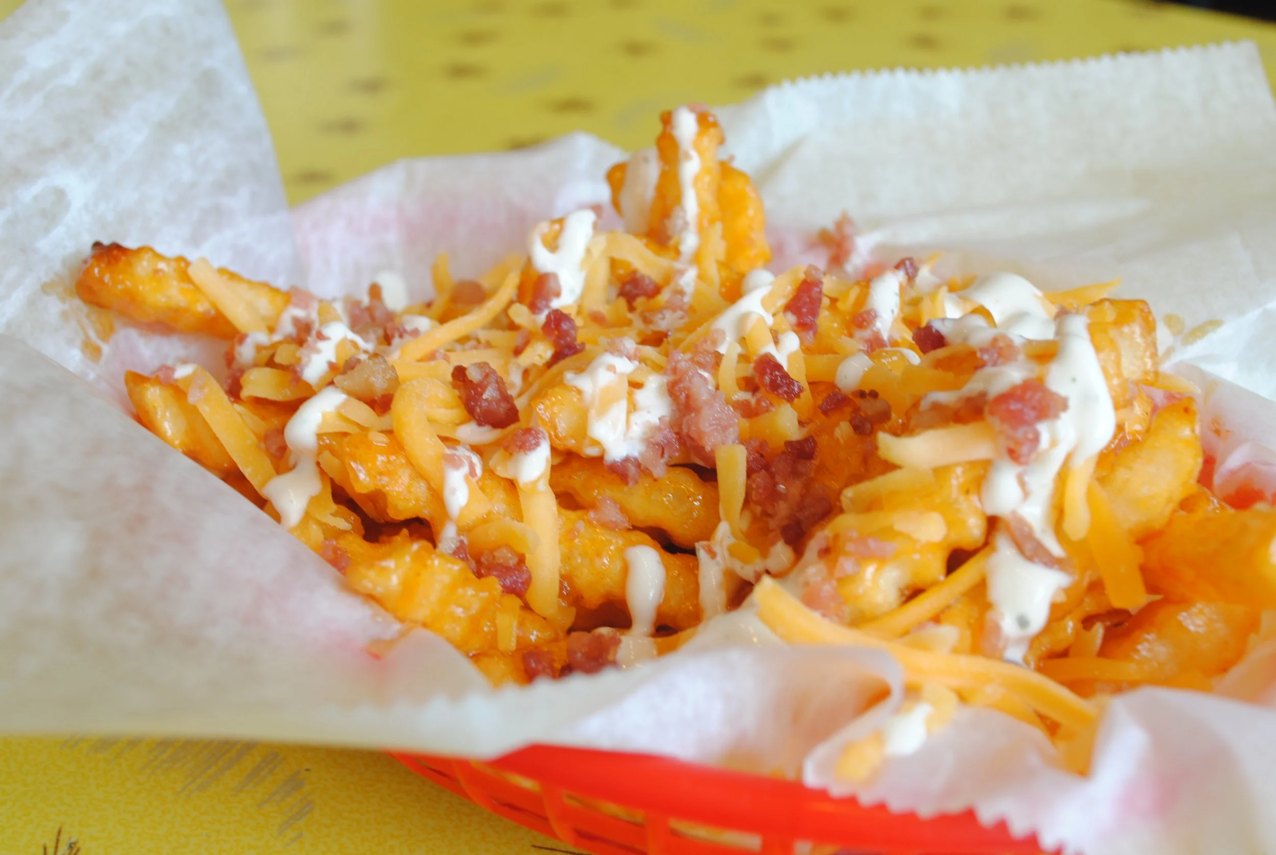 Darth Tader Fries: Crinkle cut fries tossed in Buffalo sauce topped with ranch, bacon and cheddar cheese.
