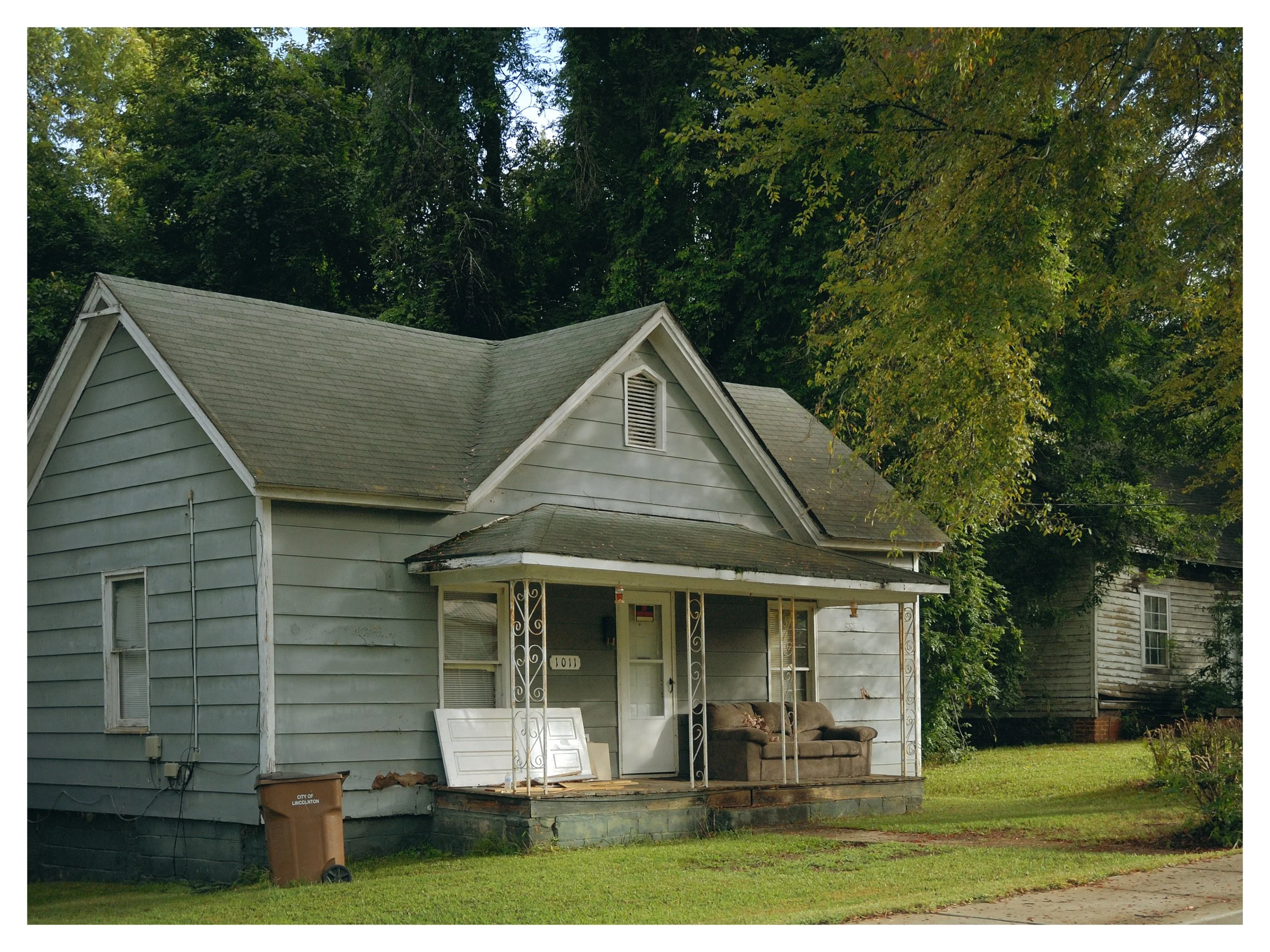 I am hoping the door on the porch means someone is fixing the home.  I really like these old homes.