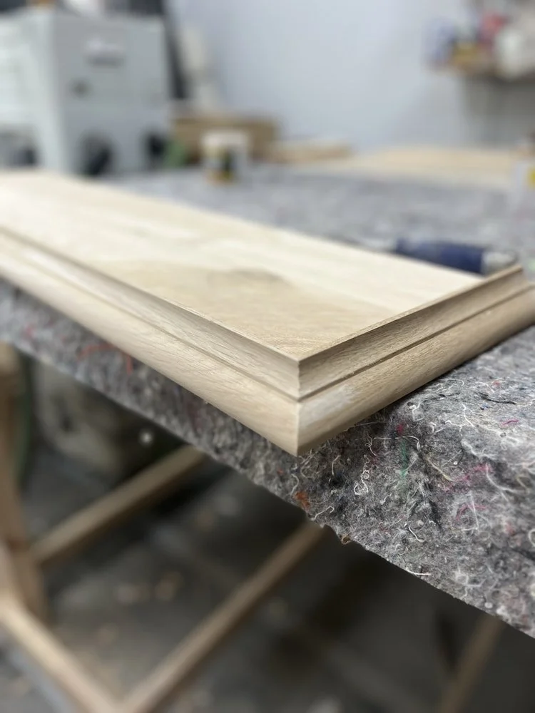 Close-up detail of precision mitered oak molding crafted in the joinery workshop