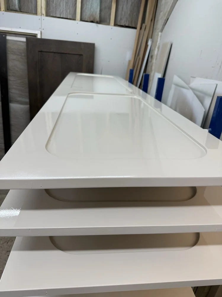 High-build spray finish application on a custom door panel in the workshop spray booth