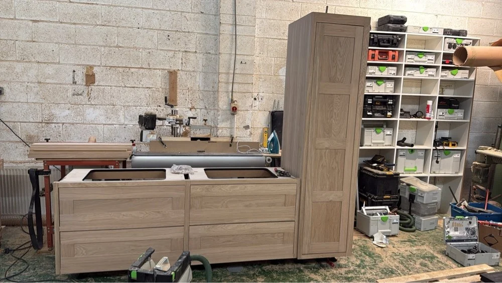 Bespoke double oak bathroom vanity unit and attached tall storage cabinet being handcrafted in the workshop in Stotfold Hertfordshire by Ken Pope Custom Joinery