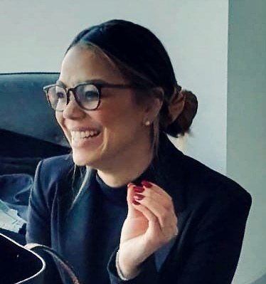 Olivia Brice laughing mid-conversation