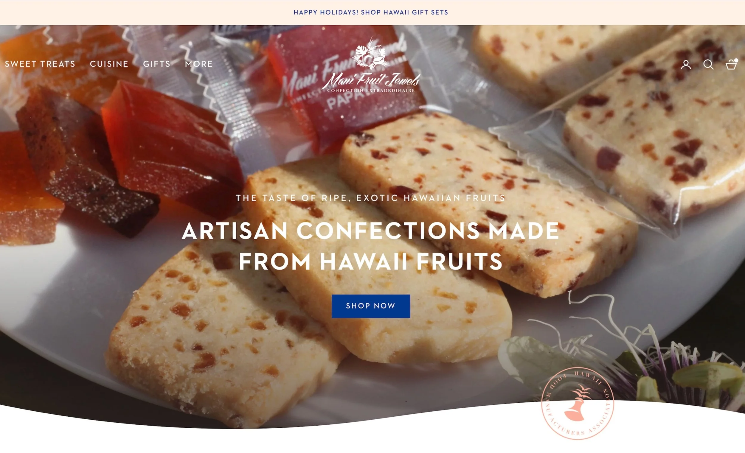 A website thumbnail of Maui Fruit Jewels featuring close-up of assorted artisan confections, including fruit jellies and fruit bars, on a white plate with text overlay promoting Hawaii gift sets and artisan confectionery from Hawaii.
