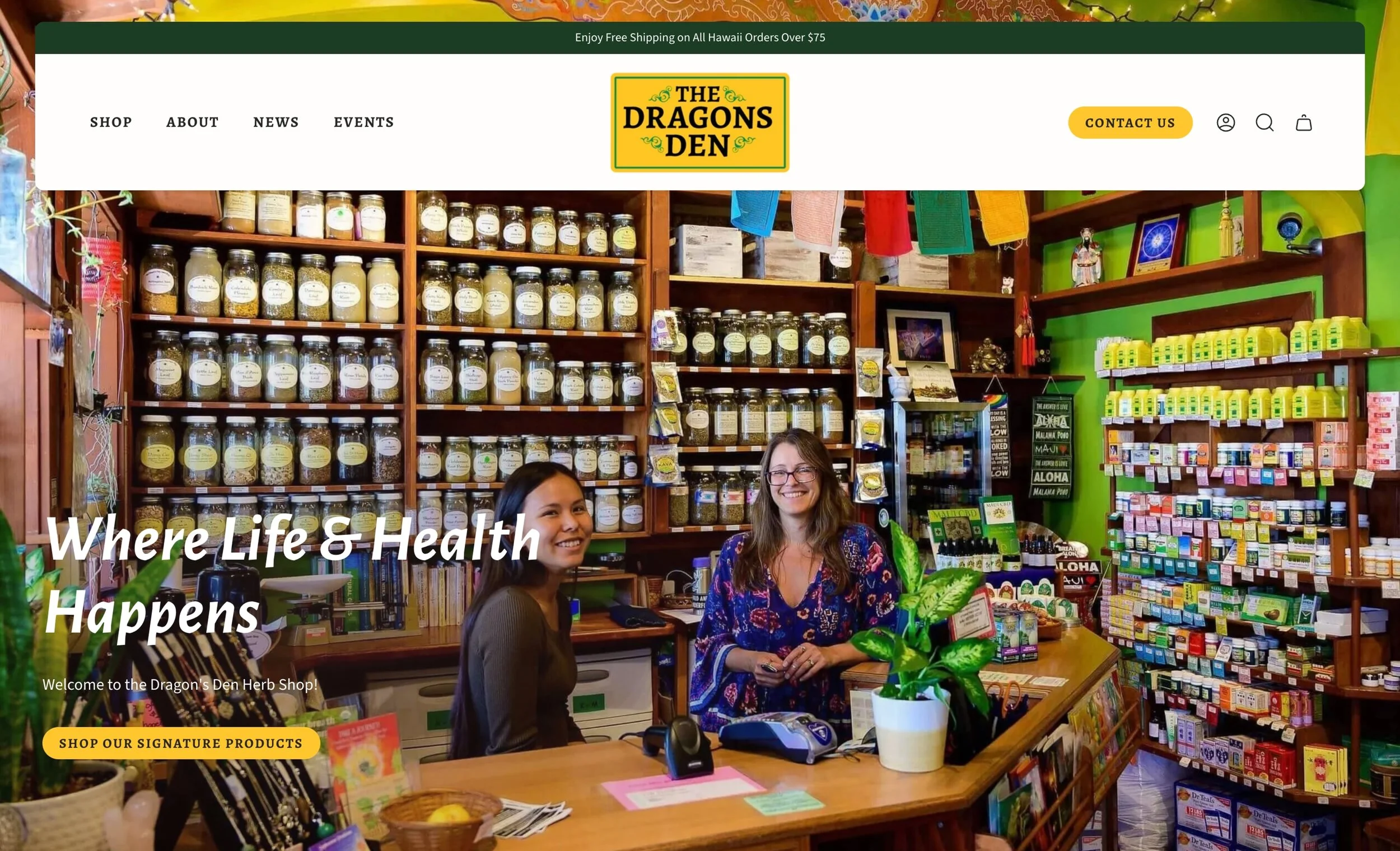 Thumbnail of homepage for Dragons Den Maui showing the inside the Dragon's Den Herb Shop with shelves of jars and products, two women smiling behind the counter, colorful decor, and gardening items surrounding the shop.