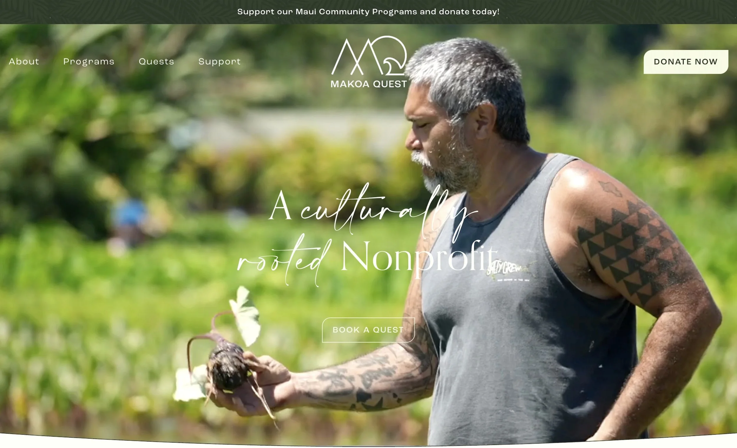 A man with tattoos, gray hair, and a beard examines a young plant outdoors, with lush green trees in the background. The webpage header promotes Maui community programs and donations.