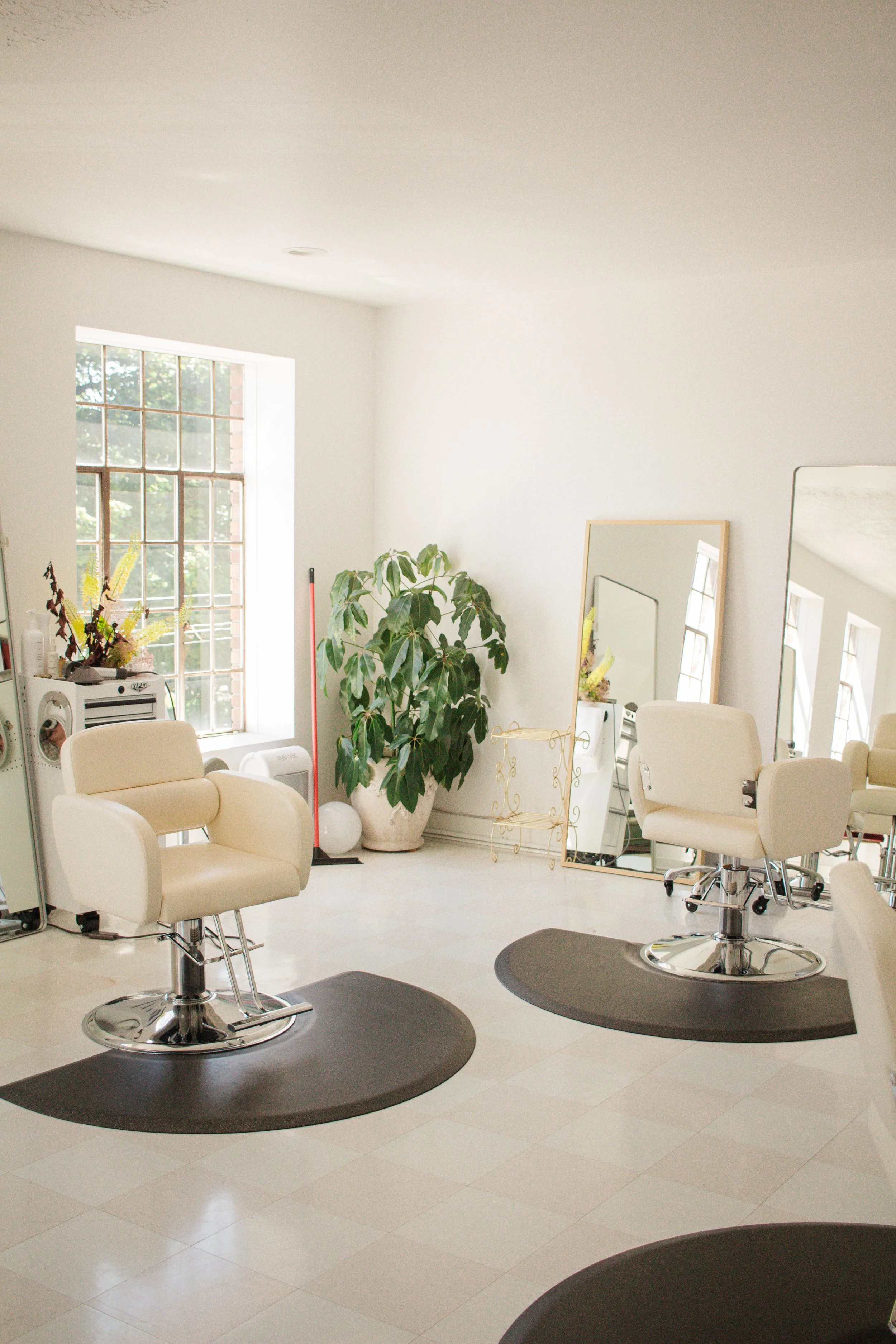 Two salon chairs in a brightly lit room at Hedon HQ in Portland, Oregon