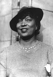 picture of a woman smiling wearing a black hat