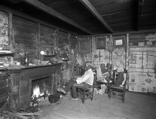 man sitting in wooden chair in front of a fireplace