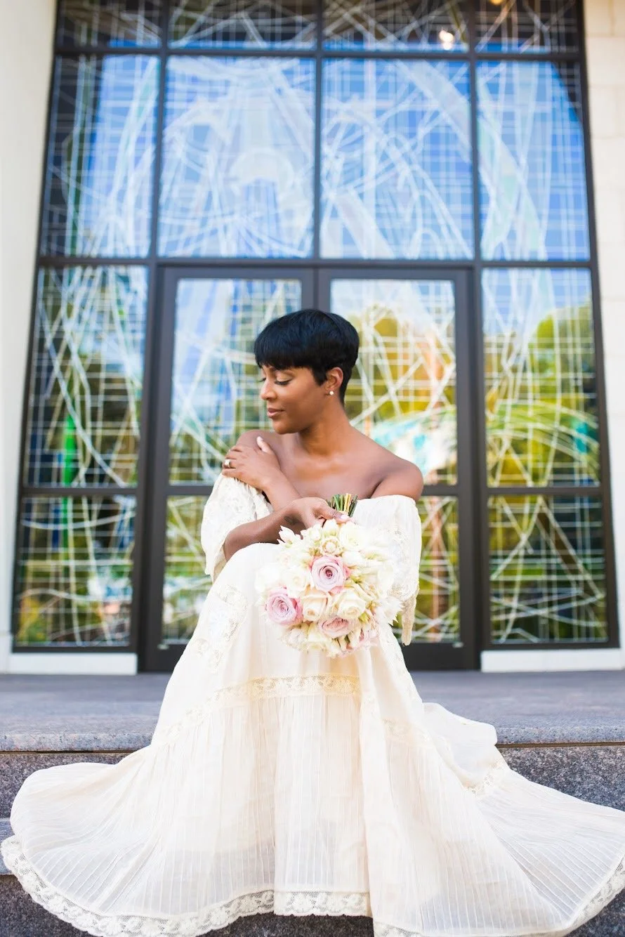 Bride seated holding flowers