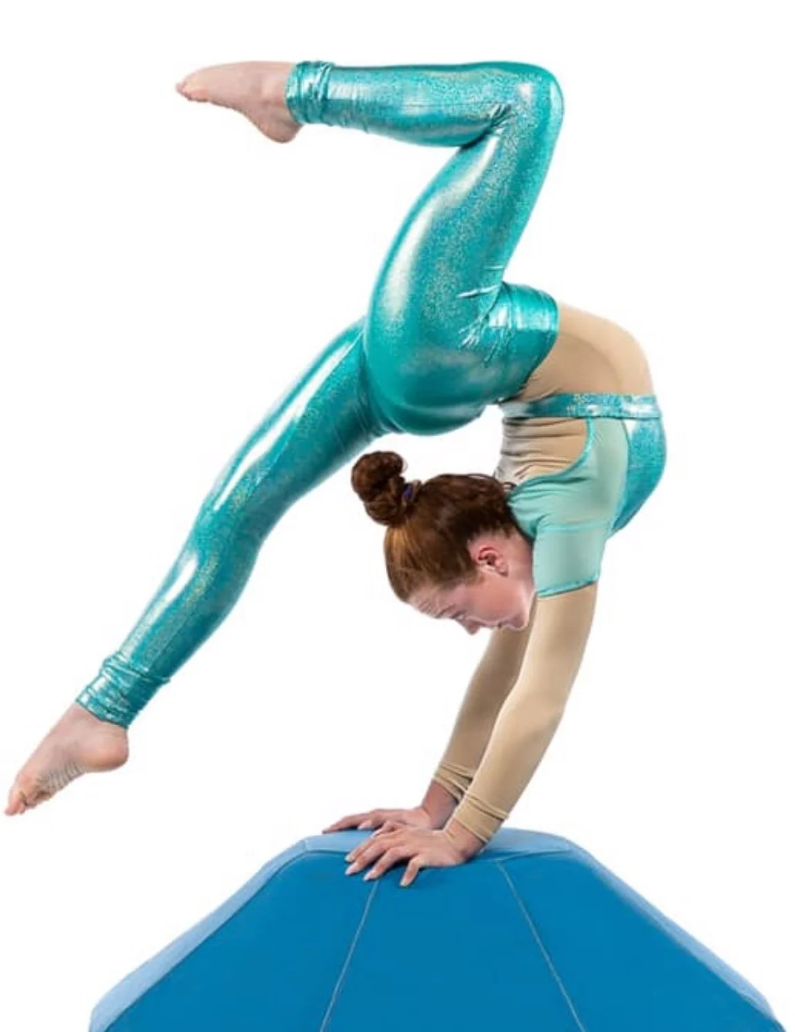 A female gymnast performing a handstand on a blue balance beam, wearing a sparkly turquoise and beige leotard, with her body bent into a backbend and one leg extended upward.